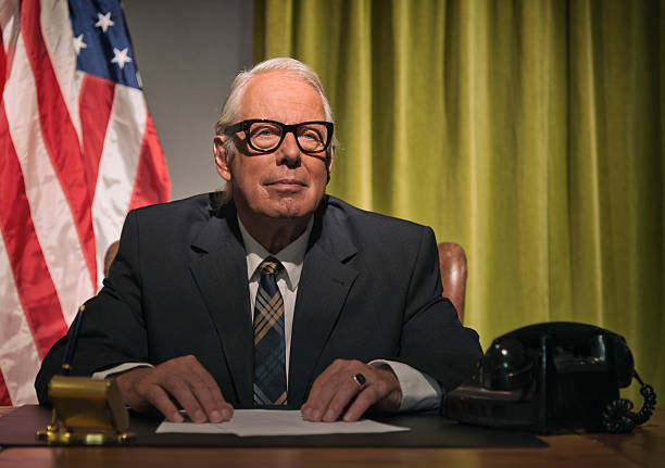 istock Big boss president wearing glasses sitting behind desk. 512082239