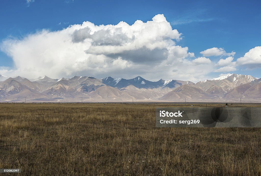 Incredible color of the sky and clouds over Tibetan plain Incredible color of the sky and clouds over flat Tibetan plain Backgrounds Stock Photo