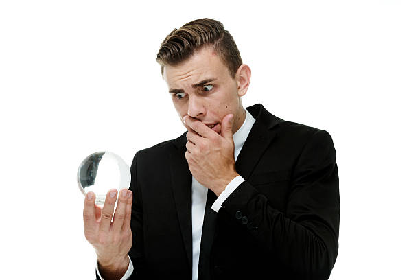 istock Scared businessman looking into crystal ball 512082457
