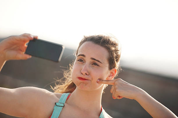 istock Young Woman Taking Selfie 512082737