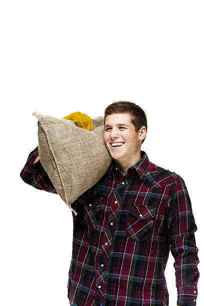 istock Cheerful farmer holding burlap sack 512082739