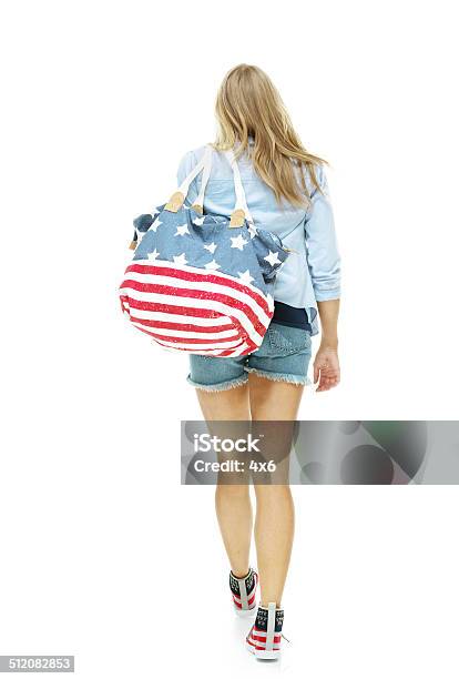 Rear View Of Woman Holding Purse Walking Stock Photo - Download Image Now - 20-29 Years, Adult, Adults Only