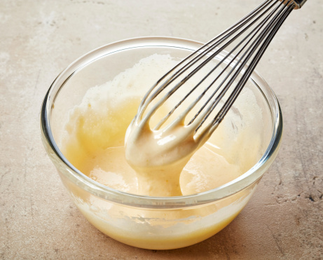 whipped egg yolks with sugar in a glass bowl