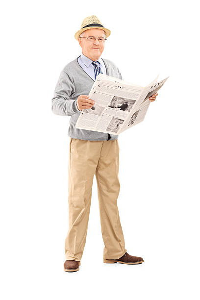 istock Senior gentleman holding a newspaper 512084827
