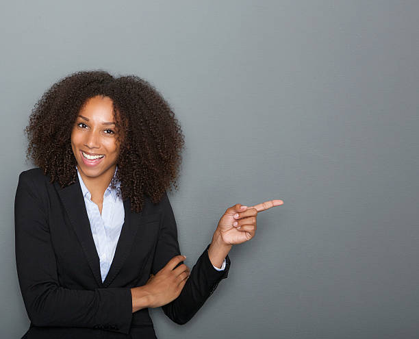 istock Smiling business woman pointing finger 512085317