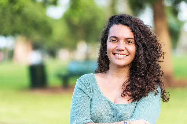 латиноамериканцы молодая женщина - spanish and portuguese ethnicity looking at camera waist up outdoors стоковые фото и изображения