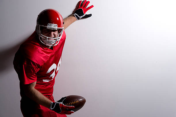 istock American football player holding ball & cheering 512086077