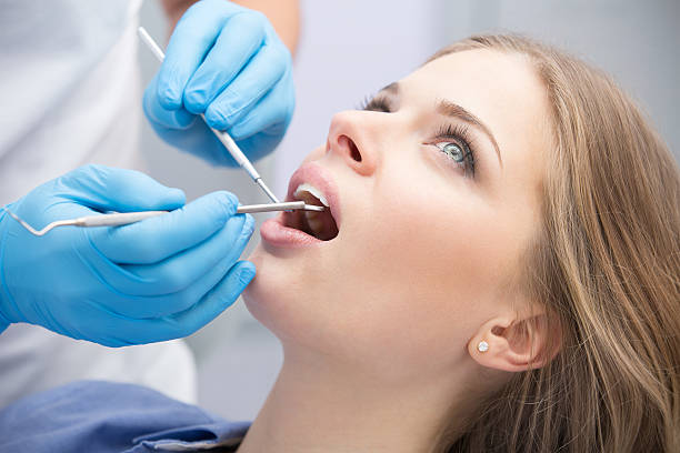 istock Dentist examining a patient's teeth in the dentist 512093296