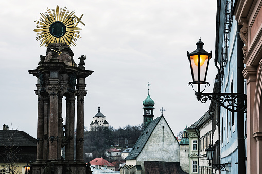 Banska Stiavnica historical cityscape with monumental plague column, New castle and Saint CatherineÂ´s church, Slovak republic, Unesco. Architectural scene.