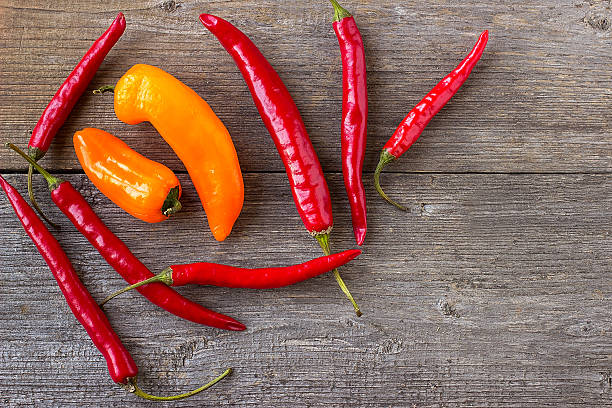 istock Red hot chili peppers on old wooden table 512095172