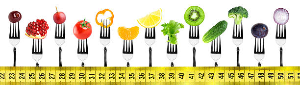 istock Fruits and vegetables on fork with measuring tape 512097002
