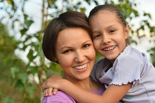 istock girl with mother in park 512098728