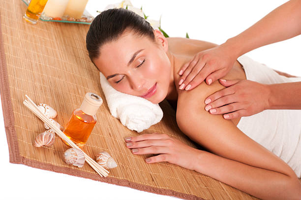 istock Relaxed beautiful young woman having a spa massage 512099041