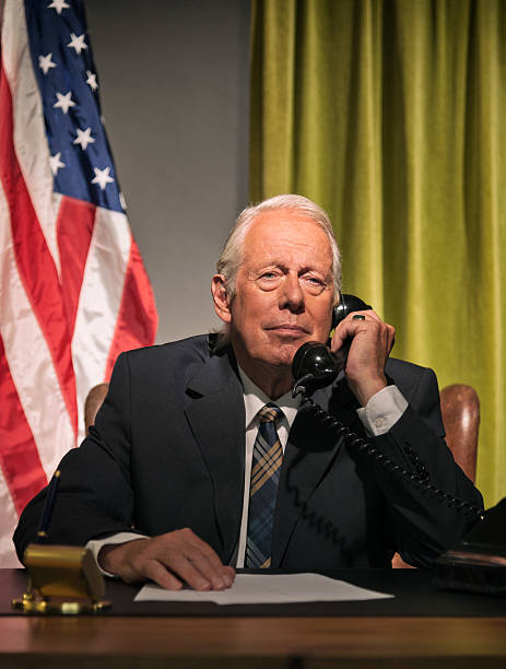 istock Big boss president calling behind desk with american flag. 512099107