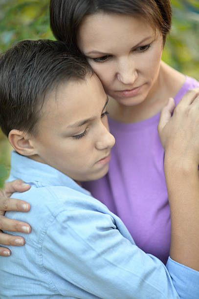 istock Sad mother with  son   in park 512099114