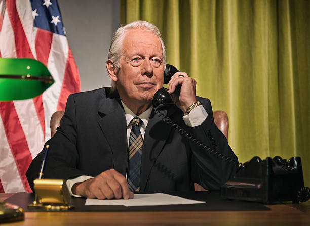 istock Big boss president calling behind desk with american flag. 512099127