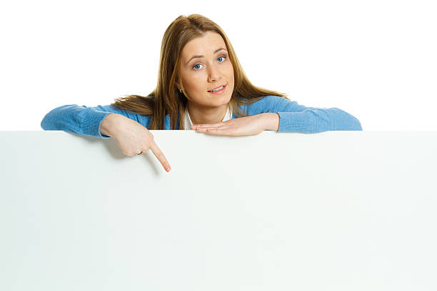 istock attractive young woman with blank ad banner 512099448