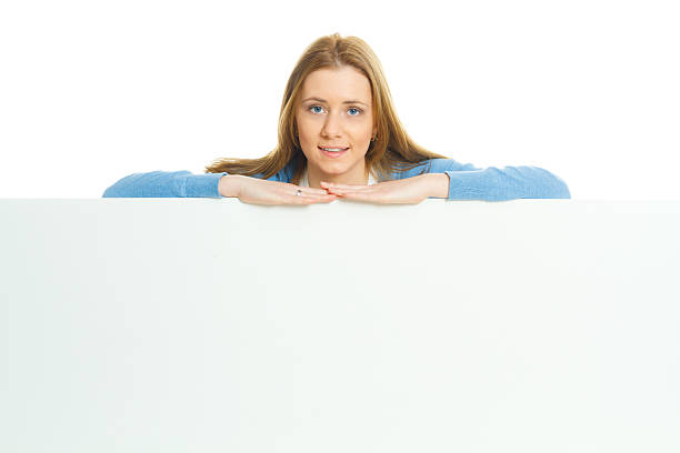 istock attractive young woman with blank ad banner 512099528