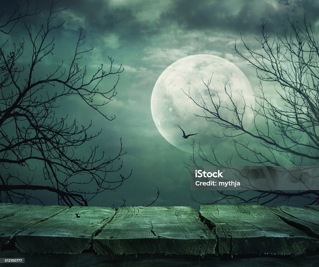 Halloween background with table Halloween background. Spooky forest with full moon and wooden table Moon Stock Photo