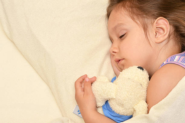 istock Little girl sleeping with a toy 512101108
