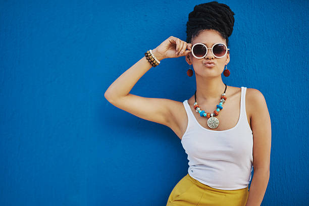 When your pout is on point Shot of an attractive young woman wearing funky sunglasses against a blue backgroundhttp://195.154.178.81/DATA/i_collage/pi/shoots/806374.jpg necklace photos stock pictures, royalty-free photos & images