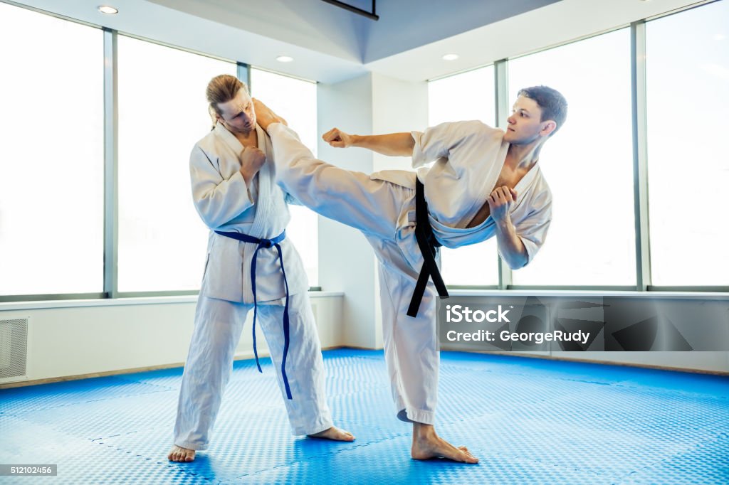 Modern fight club Two karate fighters showing technical skill while practicing Martial arts in a fight club Activity Stock Photo