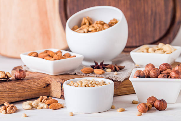 istock almonds, walnuts, hazelnuts cashews and pine nuts in wooden bowl 512103094