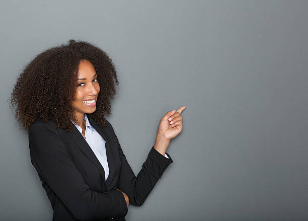 Friendly business woman pointing finger