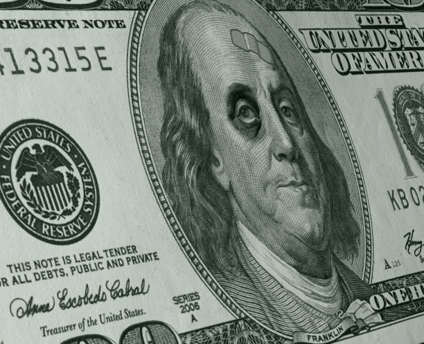 istock Ben Franklin with Black Eye and Band Aid on C-Note 512105143