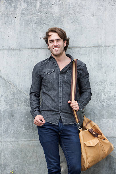 istock Fashionable young man smiling with bag 512105341