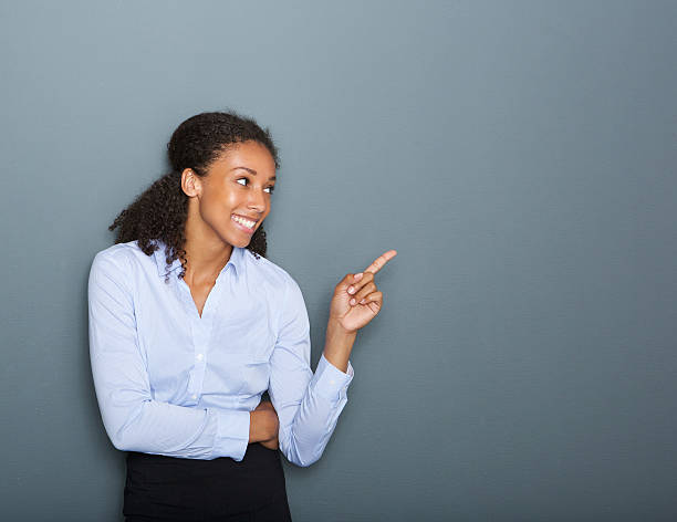 istock Happy business woman pointing finger 512105499