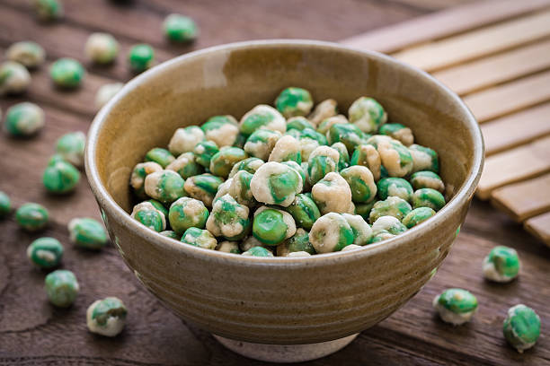 Crispy green peas in bowl Crispy green peas in bowl wasabi sauce stock pictures, royalty-free photos & images