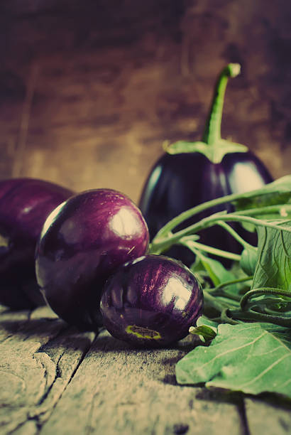istock Eggplants on the wooden background 512106305