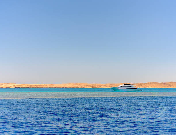 istock Pleasure boat or tour boat off a reef 512106464