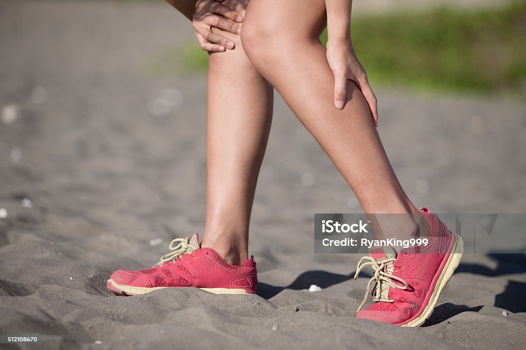 sport woman knee injury sport woman cramp in leg and feel pain, asian beauty Pain Stock Photo