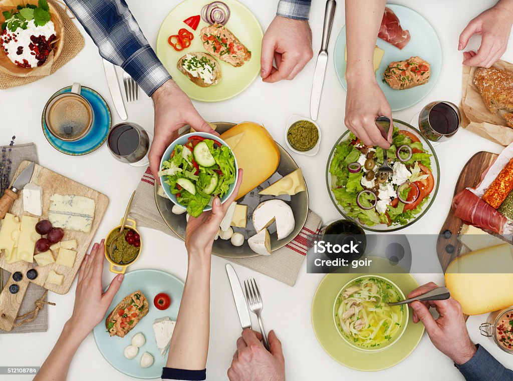 View from above the table of people eating Sharing Stock Photo