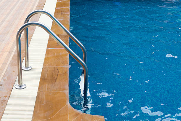 istock Swimming pool with stair at hotel close up 512108852