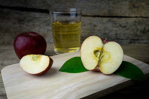 istock Apple juice and apples on a wooden table 512108960