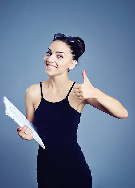 istock businesswoman holding papers in hands 512110098