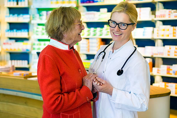 istock Laughing doctor and happy patient in pharmacy. 512111152