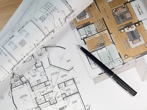 Top view of architectural blueprints and blueprint rolls