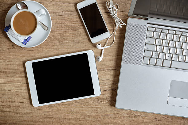 istock Laptop smartphone and coffee cup on wood 512113968