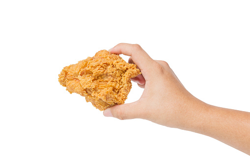 Hand hold fried chicken isolated on white background