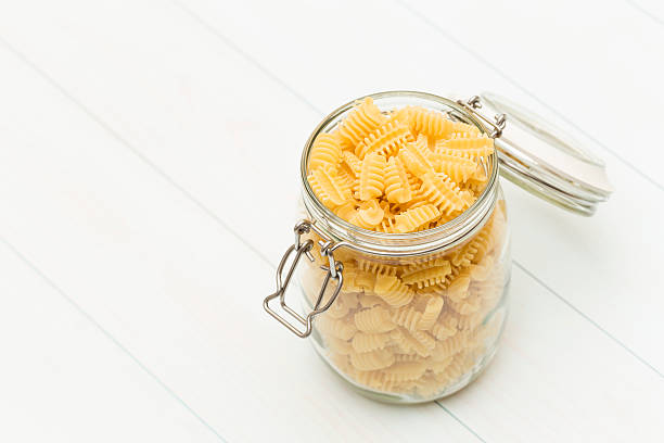 Raw radiatori pasta on a glass jar