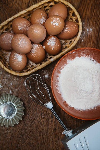 istock Baking cake  ingredients eggs, flour, sugar on wooden table 512117256