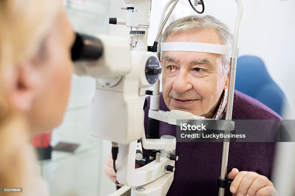 Eye specialist determines distance of eyes pupil to patient Young female eye specialist determines distance of eyes pupils to patient Eye Stock Photo