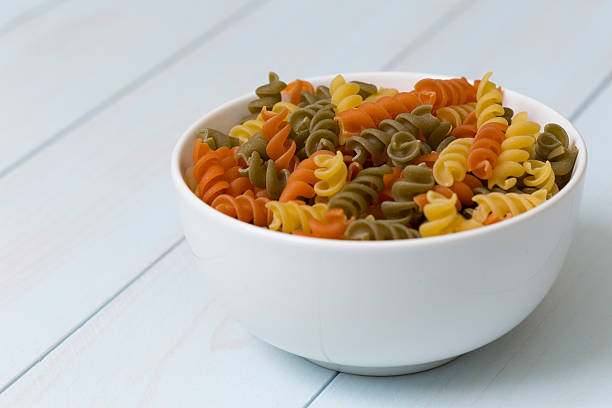 istock Raw fusilli pasta in a white bowl 512121930