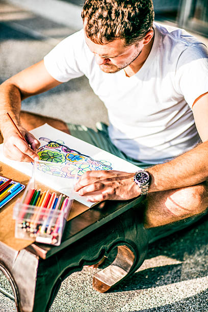 istock Adult colouring with soft tip pencils, designer, handsome men 512122198