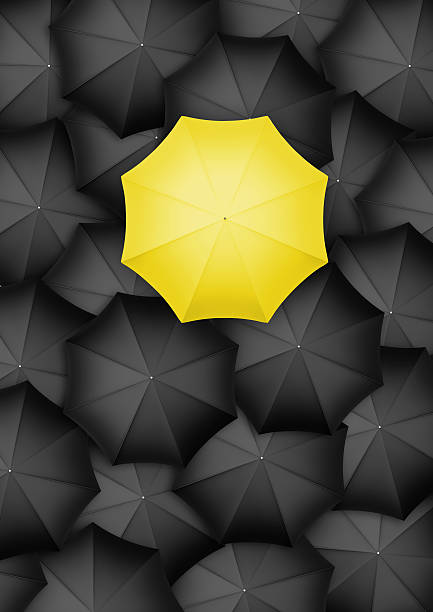 istock Yellow umbrella standing out from the rest 512122970