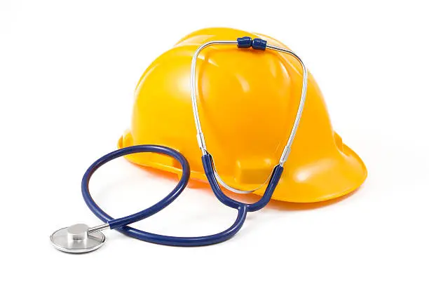 Job security concept with yellow hart hat and blue stethoscope on a white background.